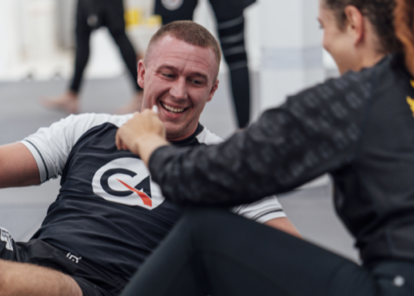Two practitioners sharing a light moment after training